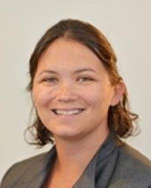 Headshot of Jamie Parreco smiling and wearing a gray blazer.