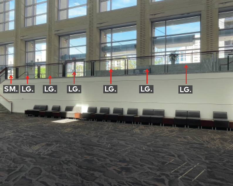 Middle mezzanine landing with railing and glass panels.