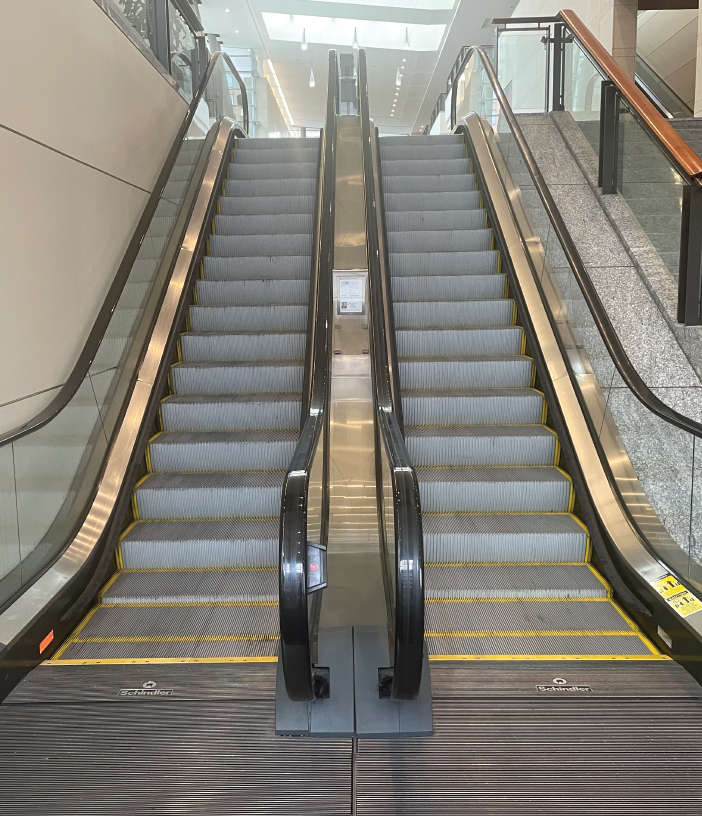 Photo taken of two escalators from bottom landing.