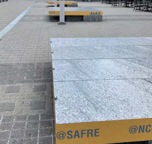 Square seating platform with client branding along the edge.