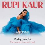 A Cover Photo of Rupi Kaur seated on the floor wearing a bright blue ball gown. Top of the image reads "RUPI KAUR" and the bottom of the image reads WOLD TOUR with the dates and cities announced in small font underneath.
