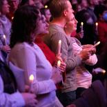 Photo of audience members holding candles