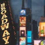 Drawing of Times Square with sign that says "Broadway" 