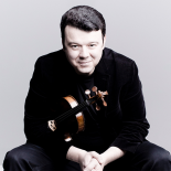 Desaturated photo of man holding violin