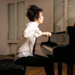 Photo of person sitting at piano