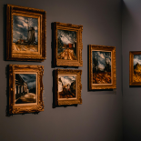 Design of gray wall with framed paintings on it 