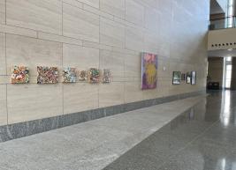 The south-facing wall of the RCC with works by Scott, Godwin, and DeMarco hanging on the walls.