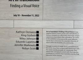 Art In Translation: Finding a Visual Voice signage outlining the description of the exhibit and artist names.
